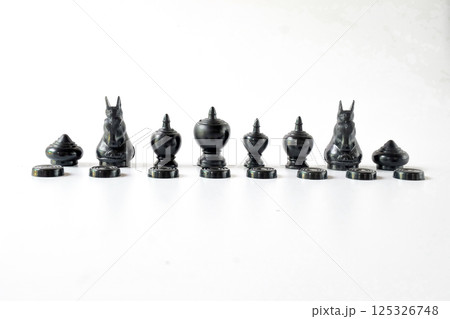 Asian black chess figurines over a white background.Asian gaming. 125326748