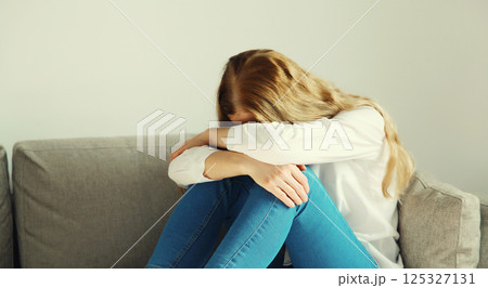 Upset sad crying woman while experiencing mental suffering, depression, fatigue, emotional stress 125327131