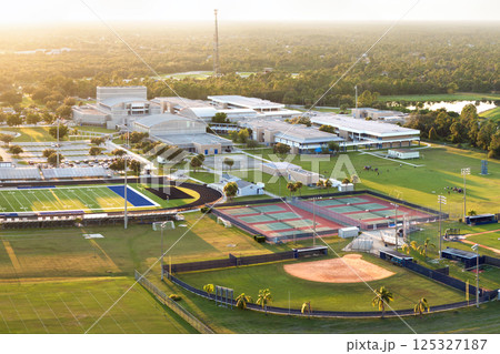 Sports facilities at public school in North Port, Florida. American football stadium, tennis court and baseball diamond sport infrastructure 125327187