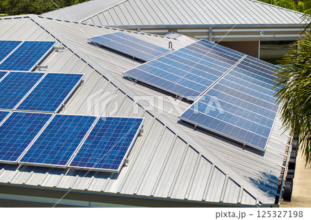 Solar photovoltaic panels mounted on house roof for producing clean ecological electric energy. Investing in renewable electricity for retirement income concept Solar photovoltaic panels mounted on house roof for producing clean ecological electric energy. Investing in renewable electricity for retirement income concept 125327198