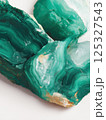 Macro close-up of malachite gemstone showing layered green rings and smooth texture. Studio mineral photography. Geology and decorative stone concept. Design for print, wallpaper, banner. Macro shot 125327543