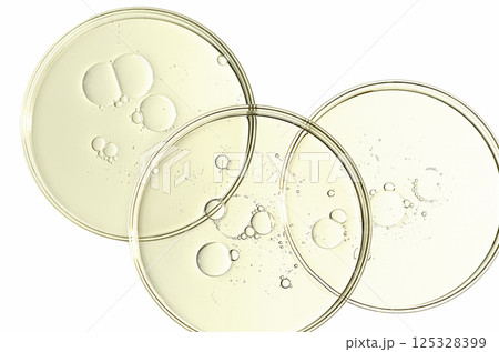 The texture of a cosmetic serum or body gel in a Petri dish. The texture of a cosmetic serum or body gel in a Petri dish. 125328399