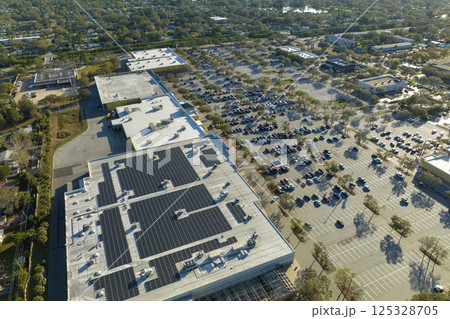 Producing of sustainable energy. Electric photovoltaic solar panels installed on shopping mall building rooftop for production of green ecological electricity Producing of sustainable energy. Electric photovoltaic solar panels installed on shopping mall building rooftop for production of green ecological electricity 125328705