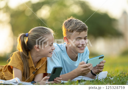 Portrait of positive happy children playing phone games. 125328759