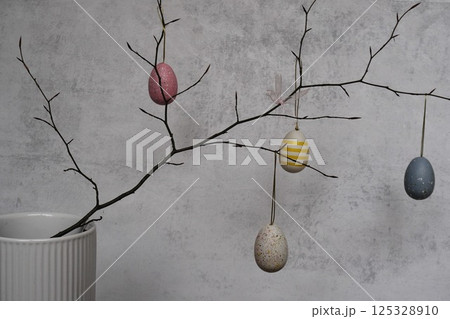 colorful eggs are on pussy twigs or branches willow. easter decor on light background with copy space 125328910