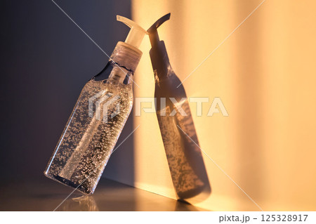 A tube of cosmetic gel or shower gel in the rays of the setting sun. 125328917