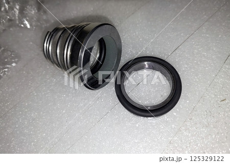Mechanical pump seal components displayed on a clean surface ready for installation and inspection 125329122