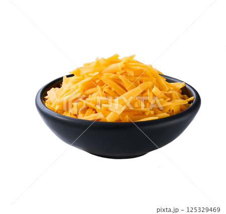shredded cheddar cheese in a black ceramic bowl isolated on a white background. 125329469