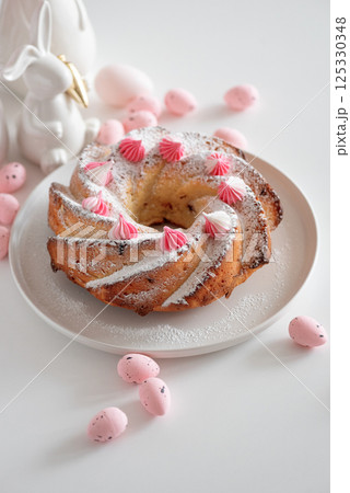 Traditional Easter cakes with icing decorated candies on white wooden table Traditional Easter cakes with icing decorated candies on white wooden table 125330348