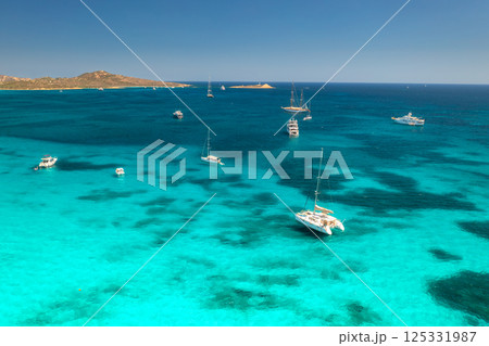 Aerial view of luxury yachts and boats on blue sea, island Aerial view of luxury yachts and boats on blue sea, island 125331987