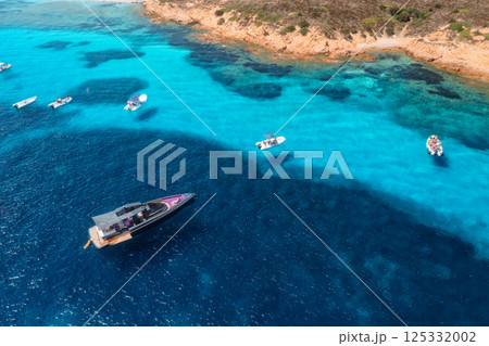 Aerial view of luxury yachts and boats on blue sea, island Aerial view of luxury yachts and boats on blue sea, island 125332002
