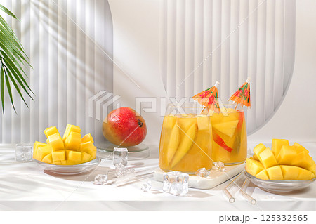 Cold homemade lemonade cocktail, mojito with mango slices, ice and fruits on sunny table, refreshing summer drink recipe, detox diet and weight loss concept, restaurant menu 125332565