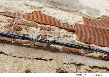 Exposed Brick Wall with Cable Installation 125332702