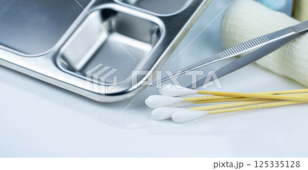 Sterile wound care dressing kit for medical professionals, featuring bandages, cotton sticks, forceps, and other essential medical supplies for infection prevention and recovery in healthcare settings 125335128