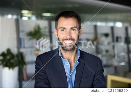 Businessman looking at camera, exuding confidence and professionalism, office portrait Businessman looking at camera, exuding confidence and professionalism, office portrait 125336299