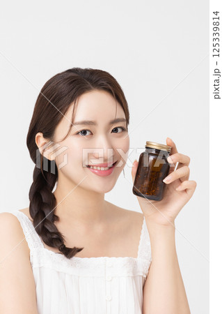 A young woman taking nutritional supplements for her health 125339814