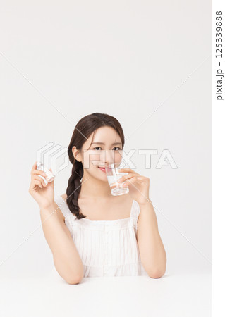 A young woman taking nutritional supplements for her health 125339888