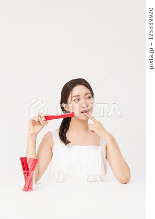Portrait of young woman posing with health supplement products 125339920