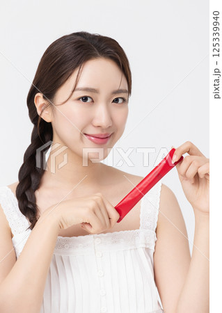 Portrait of young woman posing with health supplement products Portrait of young woman posing with health supplement products 125339940