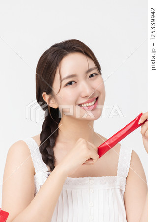 Portrait of young woman posing with health supplement products Portrait of young woman posing with health supplement products 125339942