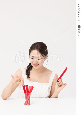 Portrait of young woman posing with health supplement products 125339977