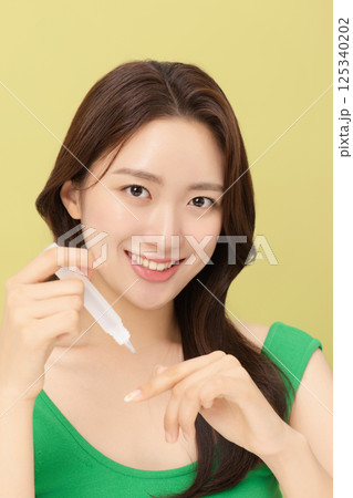 Portrait of young woman taking care of her nails 125340202