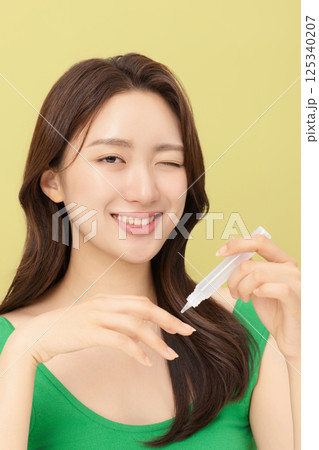 Portrait of young woman taking care of her nails 125340207