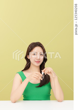 Portrait of young woman taking care of her nails 125340208
