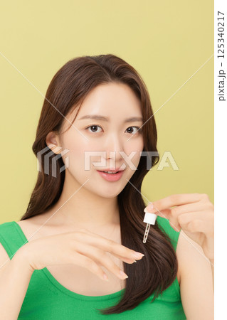 Portrait of young woman taking care of her nails 125340217