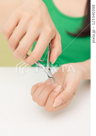 Woman's hands applying hand cream Woman's hands applying hand cream 125340398
