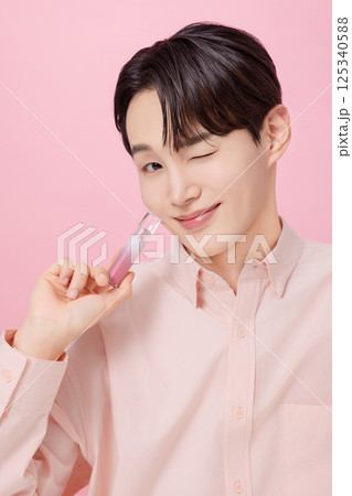 Portrait of a young man posing with a tint Portrait of a young man posing with a tint 125340588