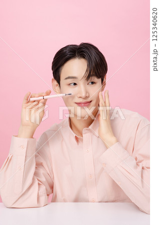Portrait of a young man posing with his eyebrows 125340620