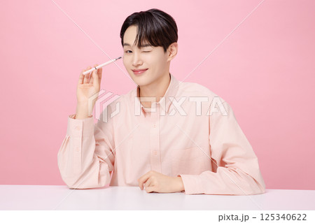 Portrait of a young man posing with his eyebrows 125340622