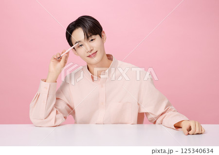 Portrait of a young man posing with his eyebrows 125340634