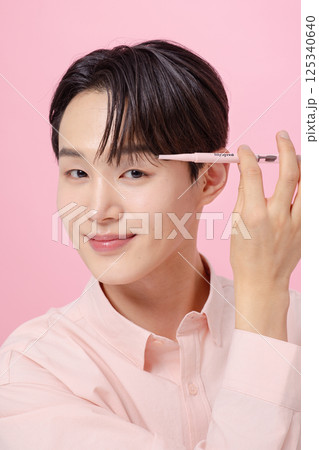 Portrait of a young man posing with his eyebrows Portrait of a young man posing with his eyebrows 125340640