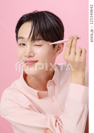 Portrait of a young man posing with his eyebrows 125340642