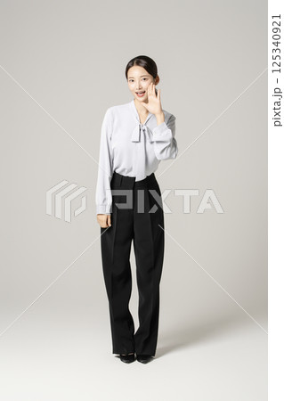 A young woman in her 20s standing in neat clothes A young woman in her 20s standing in neat clothes 125340921