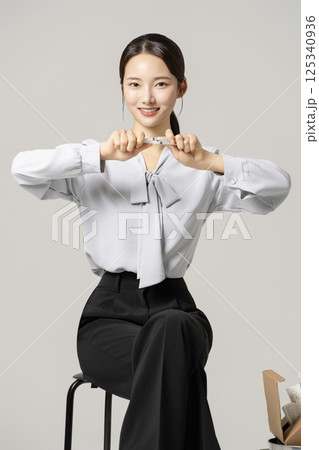 Loan leaflets scattered on the floor and a young man in his 20s feeling helpless about getting a loan. 125340936