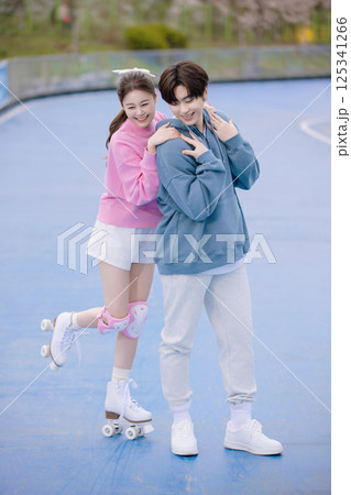 Couple skating in the park Couple skating in the park 125341266