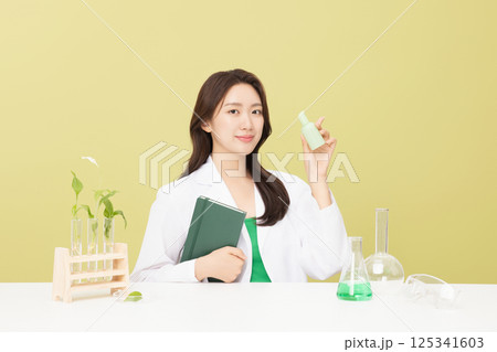 A woman wearing a doctor's gown is holding eco-friendly cosmetics 125341603