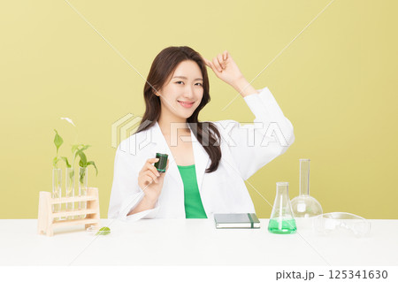A woman wearing a doctor's gown is holding eco-friendly cosmetics A woman wearing a doctor's gown is holding eco-friendly cosmetics 125341630