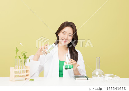 A woman wearing a doctor's gown is holding eco-friendly cosmetics A woman wearing a doctor's gown is holding eco-friendly cosmetics 125341658