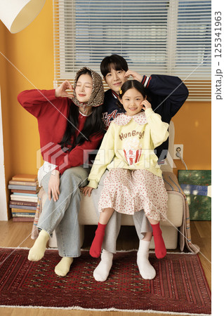 A family standing together holding hands A family standing together holding hands 125341963