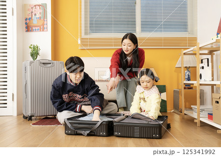 Extroverted family sitting on the sofa and taking a selfie together Extroverted family sitting on the sofa and taking a selfie together 125341992