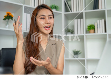 Effective Communication and Expression. A woman animatedly explaining concepts during a video meeting. 125342542