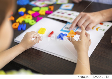 Child learning spelling with colorful letters 125342918