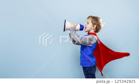 Boy in superhero costume with megaphone 125342925