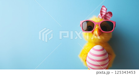 cute yellow chick wearing pink sunglasses and holding striped Easter egg cute yellow chick wearing pink sunglasses and holding striped Easter egg 125343453