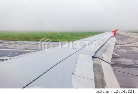 View from the airplane window during taking off on a clear summer morning. Yekaterinburg, Russia 125343821