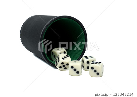 Tipped black dice cup spilling out random assortment of white dice set against a white backdrop Tipped black dice cup spilling out random assortment of white dice set against a white backdrop 125345214